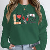 Nurse Love #Nurselife Graphic Sweatshirt in Green, front view on a model, hands in jean pockets