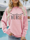 Registered Nurse Hearts Pullover Sweatshirt in Pink, front view on a model by a pool