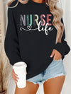 Nurse Life Pastel Letters Sweatshirt in Black, front view on a model holding a coffee cup
