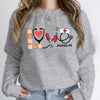 Nurse Love #Nurselife Graphic Sweatshirt in Gray, front view on a model, hands in jean pockets