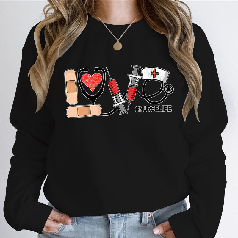 Nurse Love #Nurselife Graphic Sweatshirt in Black, front view on a model, hands in jean pockets
