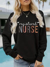 Registered Nurse Hearts Pullover Sweatshirt in Black, front view on a model by a pool