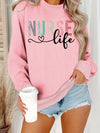 Nurse Life Pastel Letters Sweatshirt in Pink, front view on a model holding a coffee cup