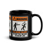Don't Tell Me How to Do My Job black glossy mug, 11 oz, the WARNING safety-sign placard facing forward with the handle at right, studio view