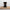 Don't Tell Me How to Do My Job black glossy mug, 15 oz, on a wooden board seen from the back, the placard wrapping out of view