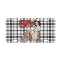 Rectum? Damn Near Killed 'Em! Vanity Plate flat front view, plaid background behind the slogan and pin-up nurse